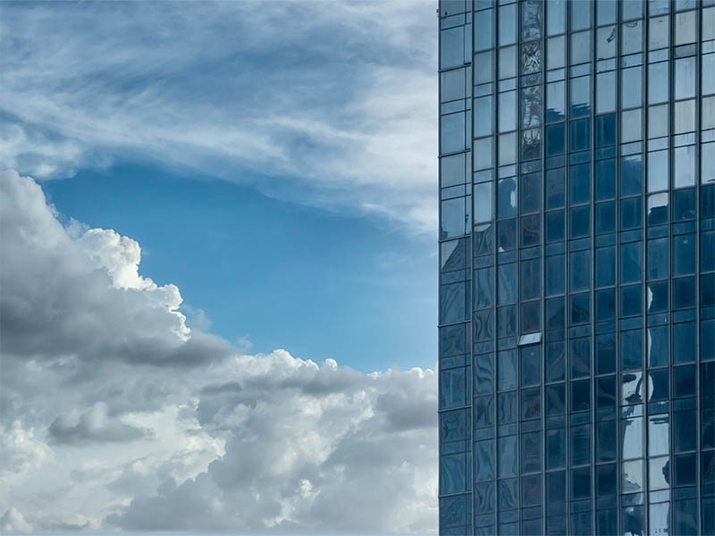 high rise buildings and clouds
