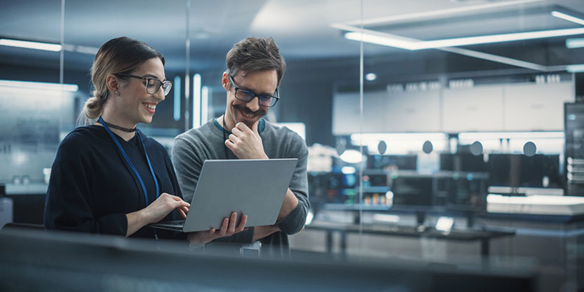 Employees with laptop and discussing