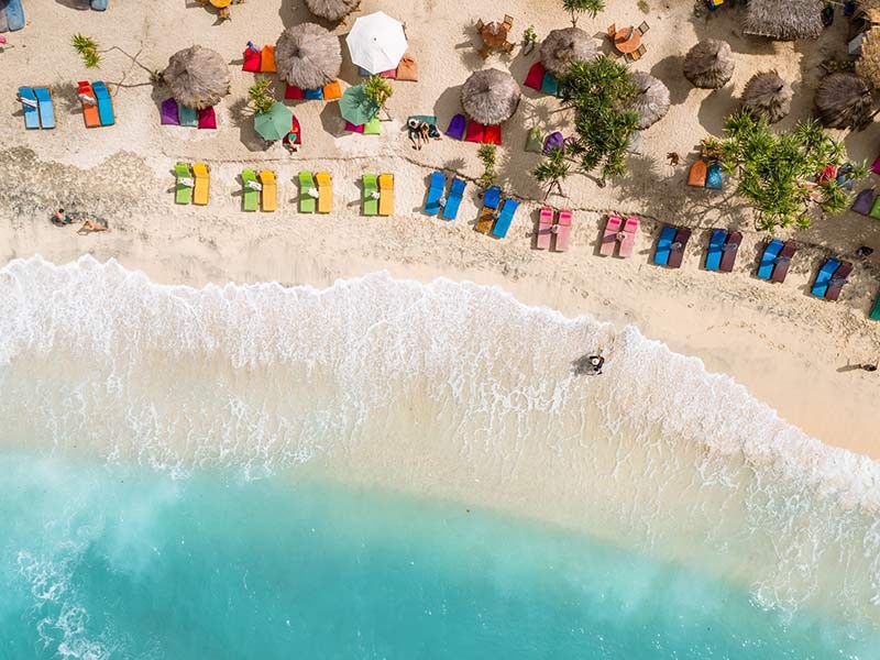 Sandy beach with colorful sun umbrella