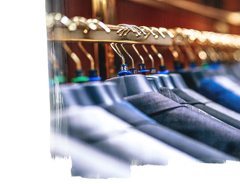 Men's suits on hangers in boutique store