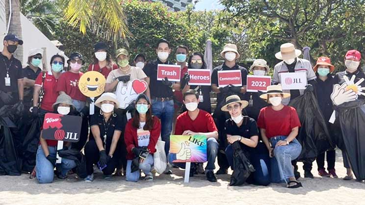 JLL employees collecting trash along a beach in Pattaya, Thailand