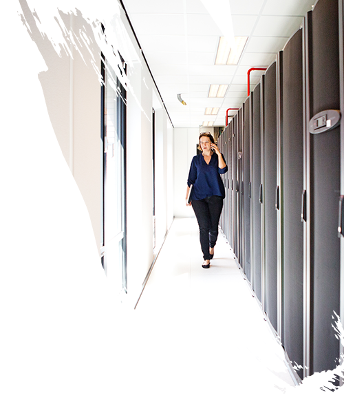 self-storage lady manager discussing over phone while passing through storage space  
