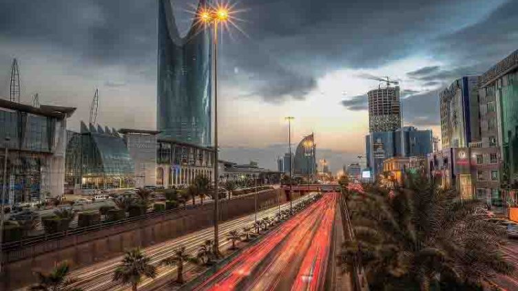 Night view of Saudi Arabia highway with commercial building on the side of highway