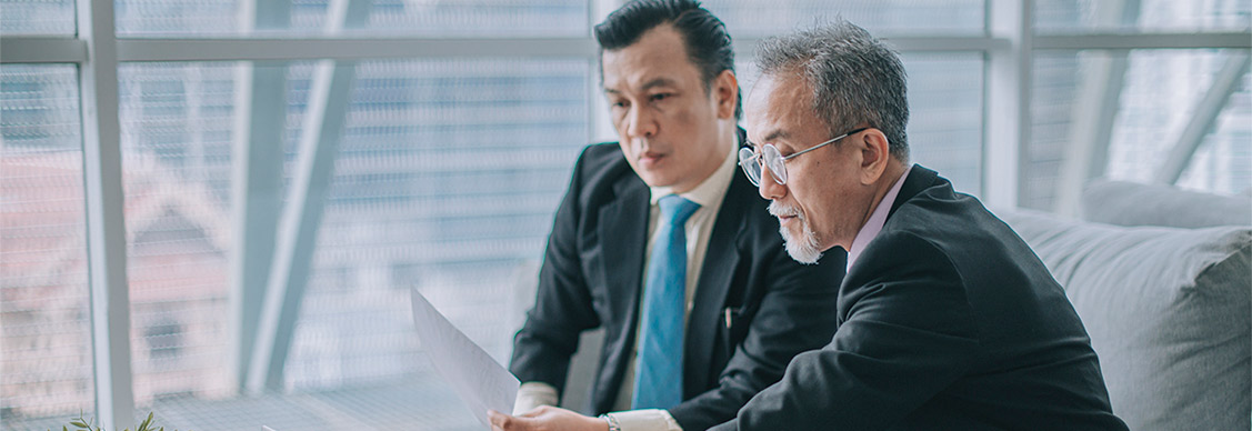 Two employees looking into a laptop