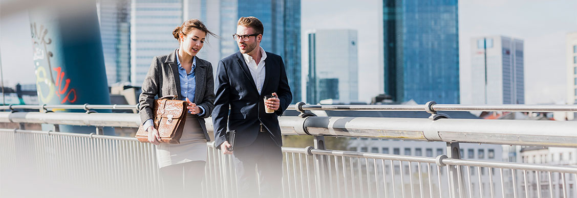 Two employees are talking and walking