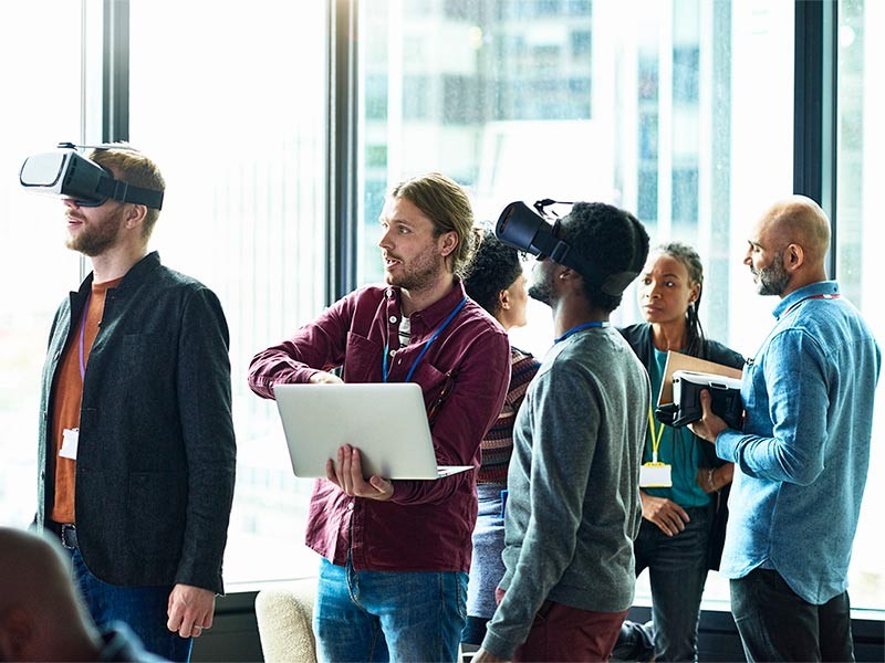 Female and male architects looking at a blueprint disussing business