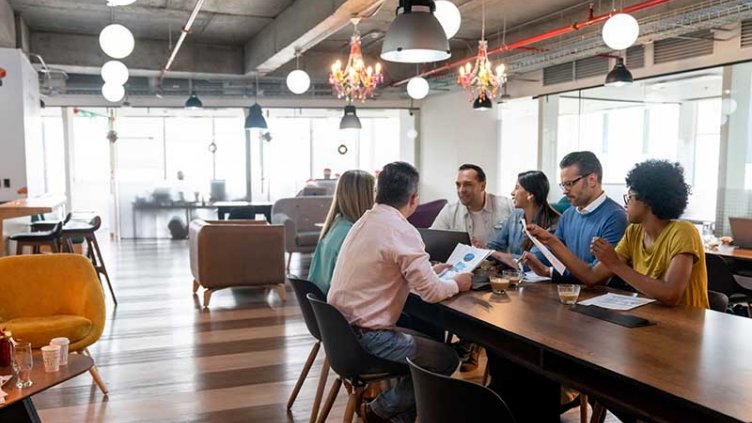 Team meeting in a modern office with multiple types of furniture