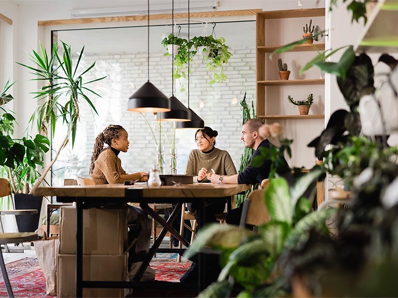 Employees having a discussion on the project details in the coworking office space