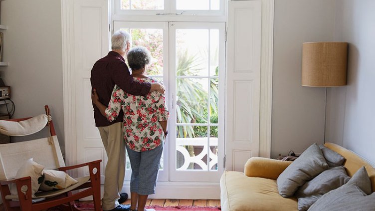 Two people looking outside the door