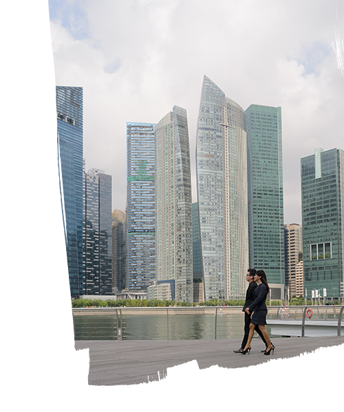 Two employees having conversation while walking beside the real estate buildings in a smart city