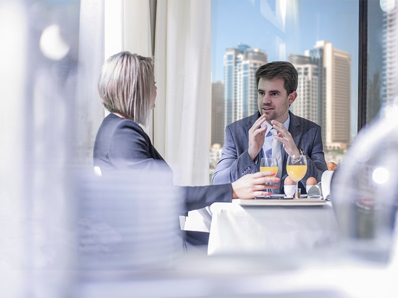 Investors discussing while having breakfast inside the office building