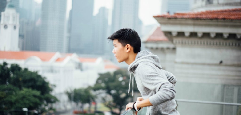 young male asian looking out 