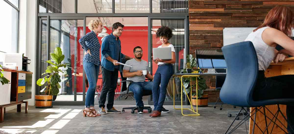 Employees working and talking in the shared office space