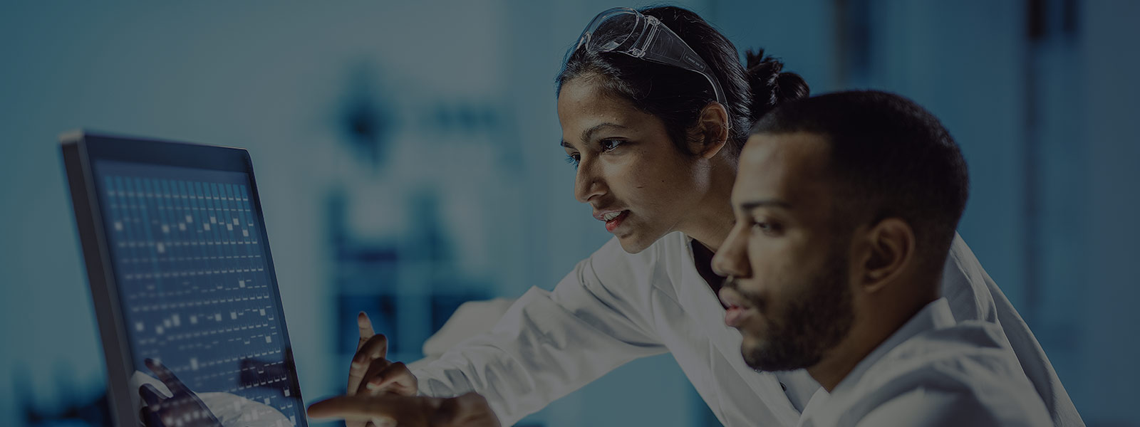 Two people working in lab.